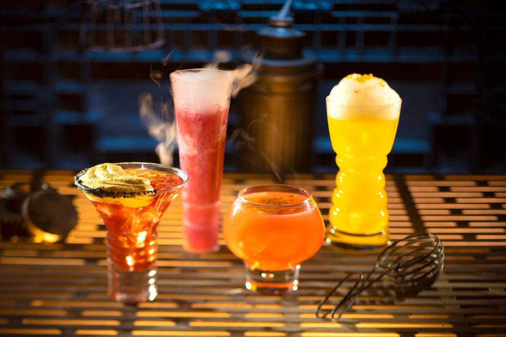From left to right, alcoholic beverages: The Outer Rim, Bespin Fizz, Yub Nub, and Fuzzy Tauntaun can be found at Oga’s Cantina.
